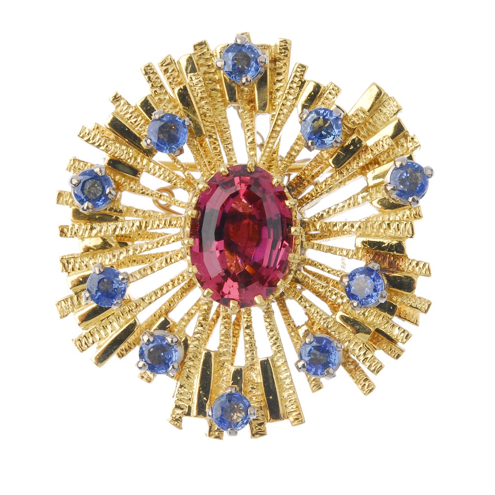 A mid 20th century tourmaline and sapphire brooch. The oval-shape pink tourmaline, within a