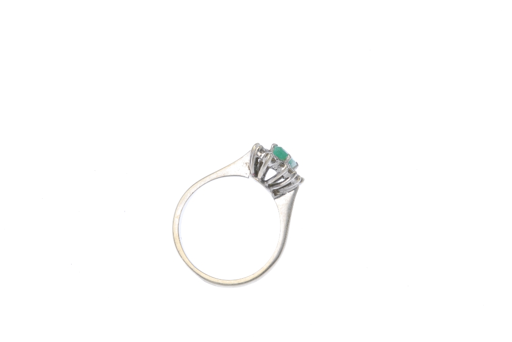 An emerald and diamond cluster ring. The marquise-shape emerald, within a brilliant-cut diamond - Image 3 of 3