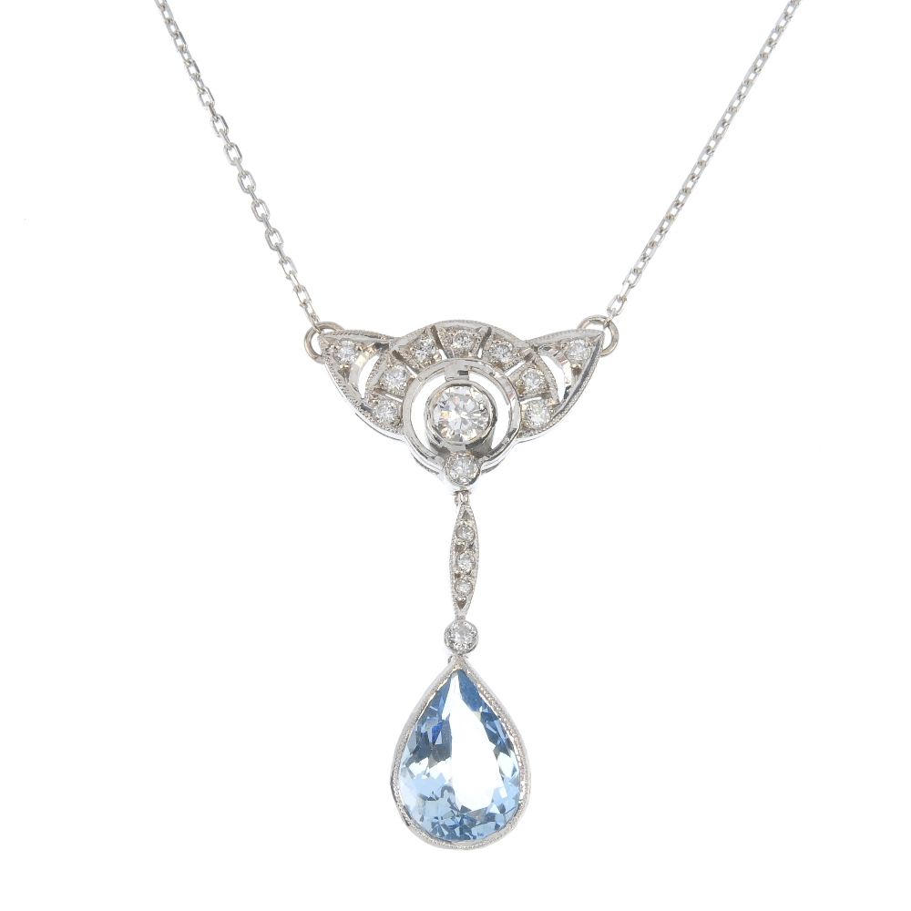 An aquamarine and diamond pendant. The pear-shape aquamarine collet, suspended from a brilliant-