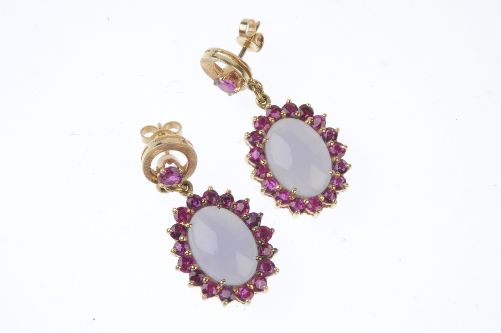 A pair of jade and ruby ear pendants. Each designed as an oval lilac jadeite cabochon, within a - Image 2 of 2