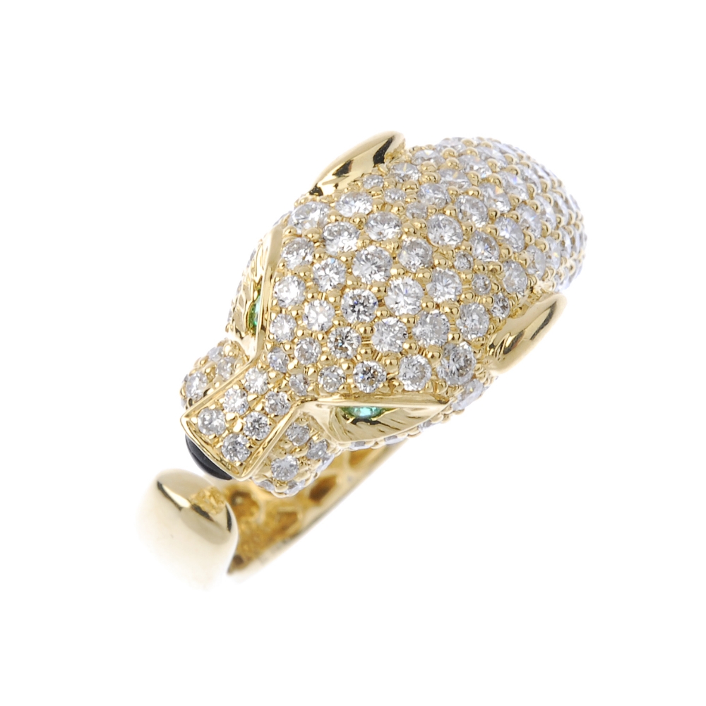 * A diamond and gem-set leopard ring. The pave-set diamond head, with circular-shape emerald eyes