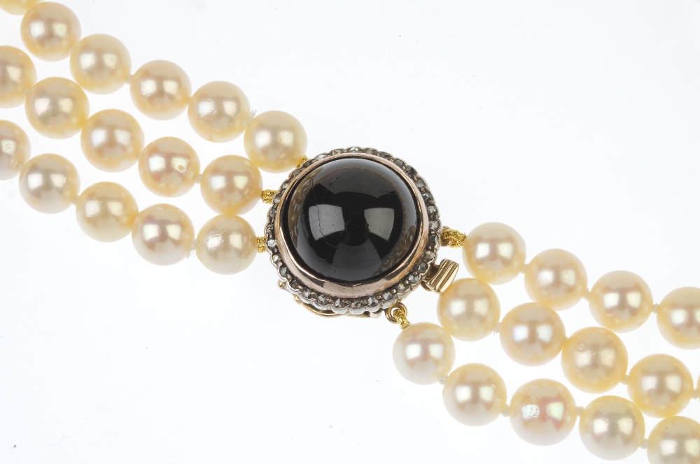 A cultured pearl three-row necklace, with garnet and rose-cut diamond clasp. The cultured pearls, - Image 2 of 3