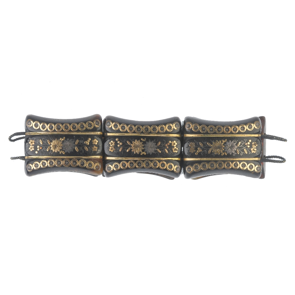 A late 19th century tortoiseshell pique bracelet. Designed as a series of tapered tortoiseshell