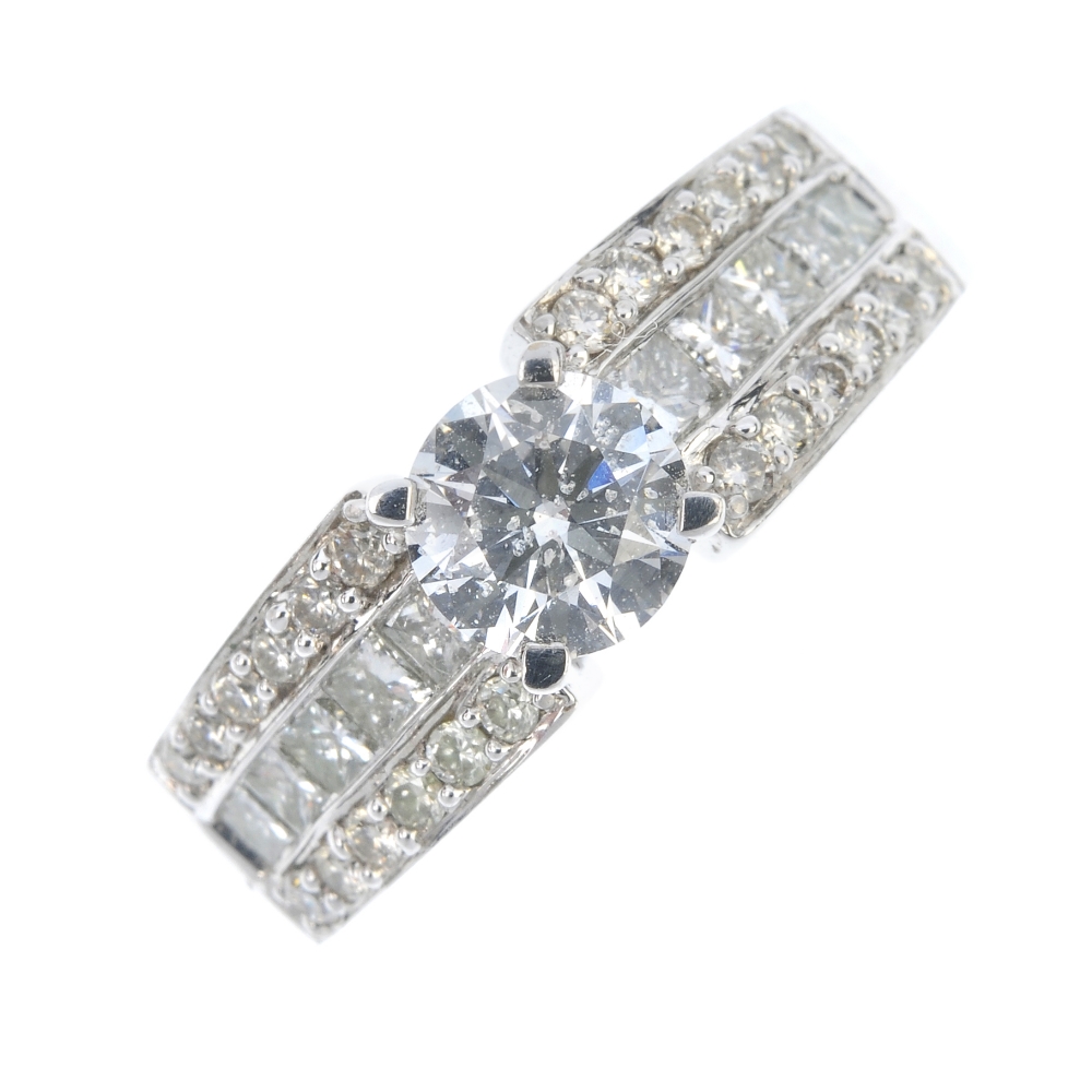 An 18ct gold diamond single-stone ring. The brilliant-cut diamond, to the similarly-cut and square-