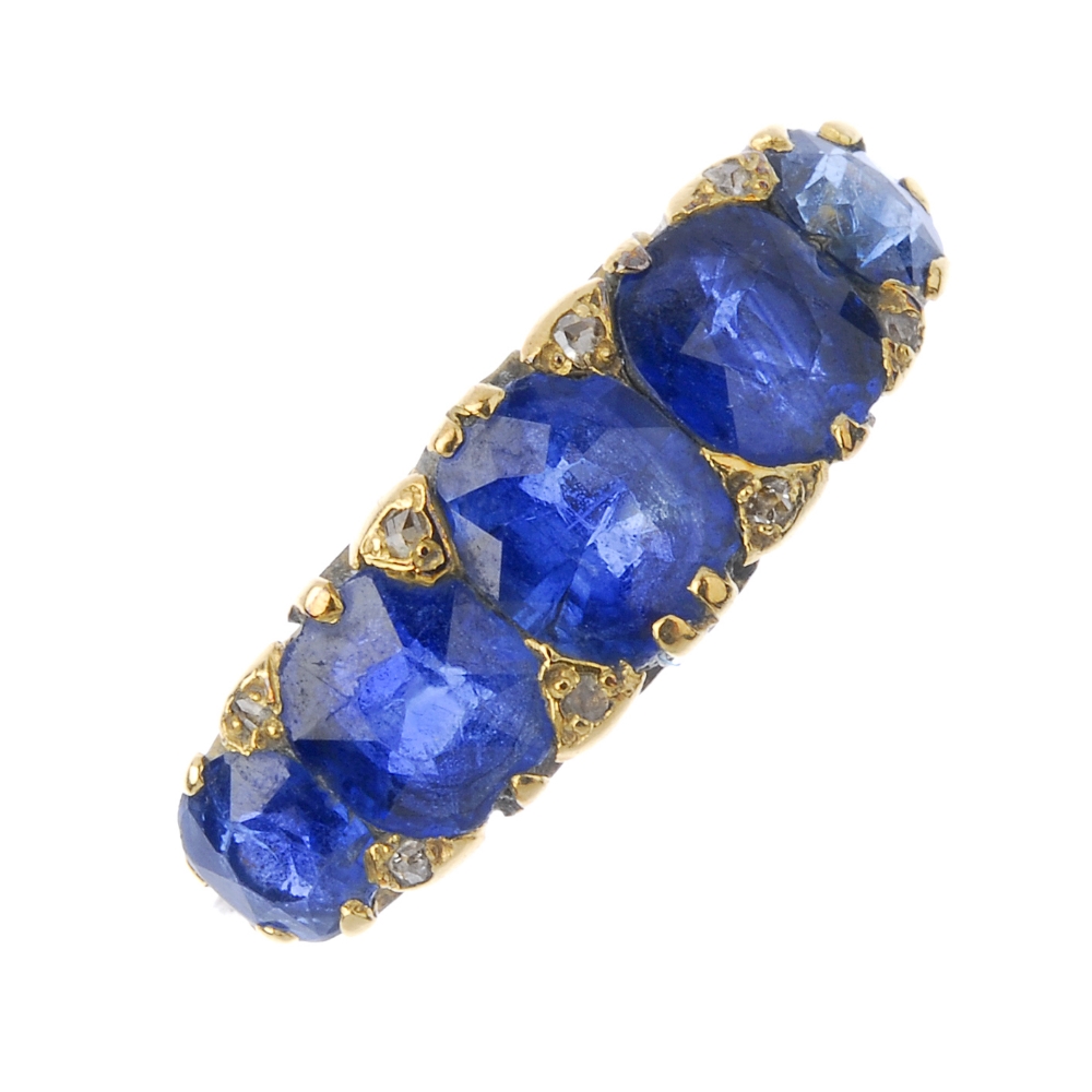 A sapphire and diamond five-stone ring. The oval-shape sapphire graduated line, between diamond