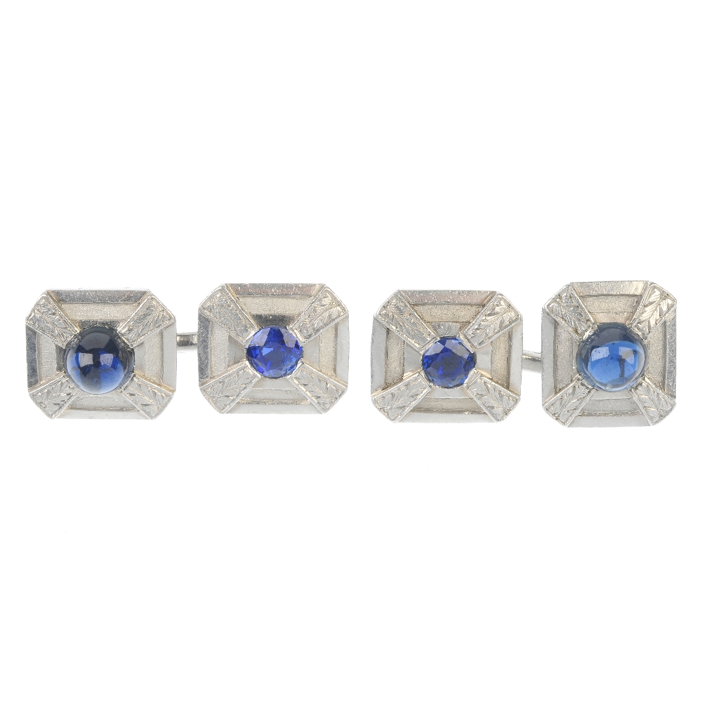 A pair of sapphire cufflinks. Each designed as a rectangular-shape panel, inset with a circular-