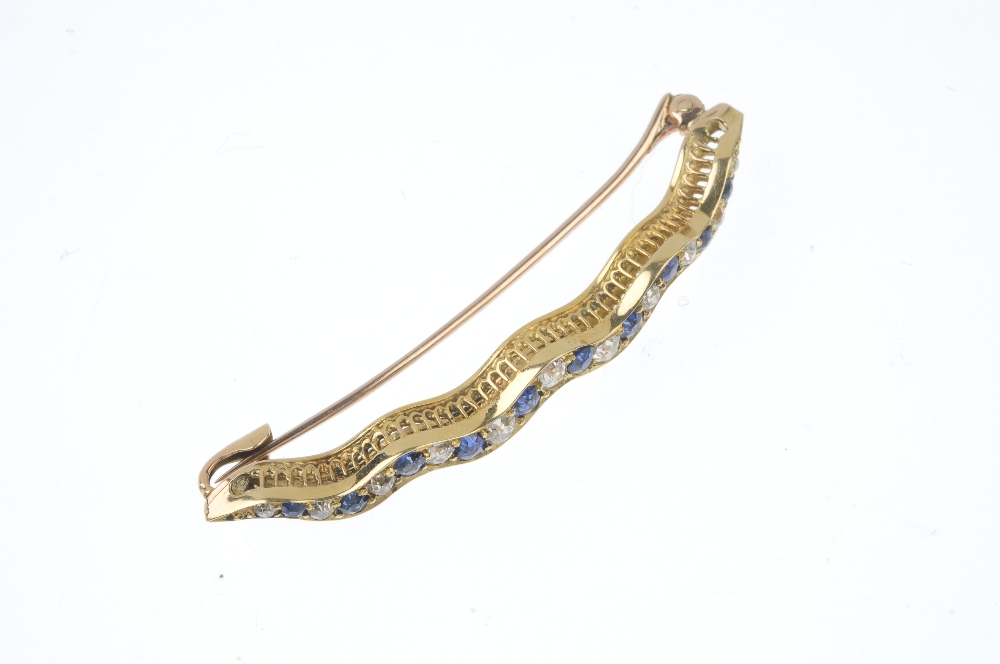 A sapphire and diamond bar brooch. Designed as an alternating circular-shape sapphire and old-cut - Image 3 of 3