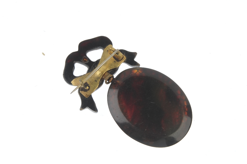 A late 19th century pique tortoiseshell brooch. The oval-shape foliate drop, to the bow surmount. - Image 2 of 2