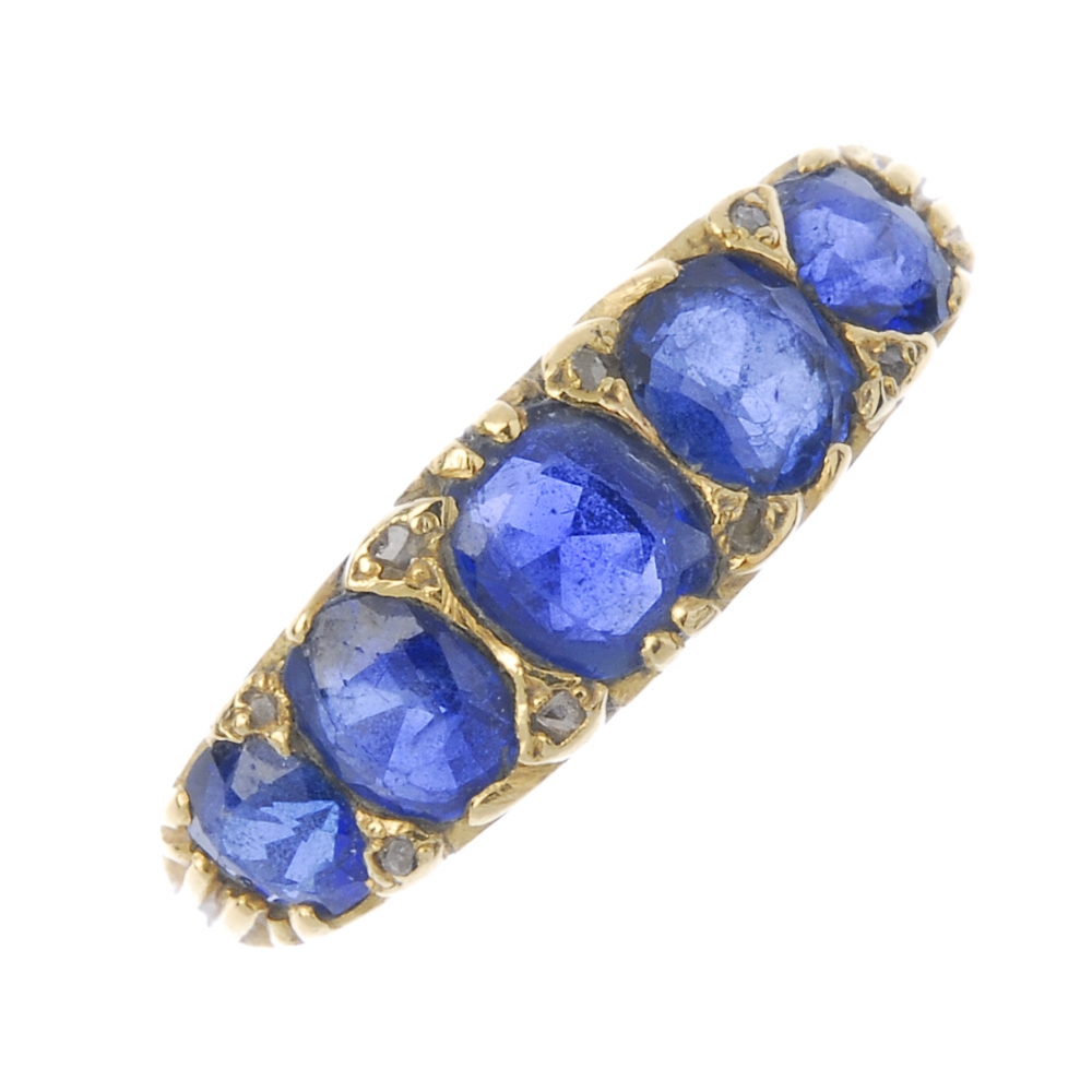 A sapphire and diamond five-stone ring. The vari-shape sapphire graduated line, with diamond point