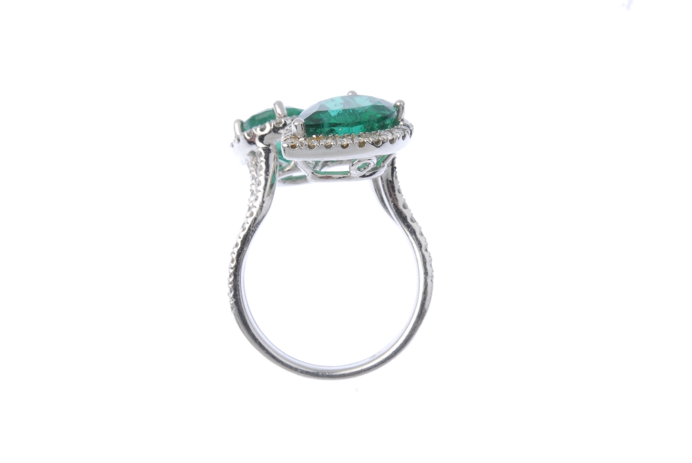 An emerald and diamond crossover ring. Designed as two graduated pear-shape emeralds, each within - Image 3 of 3