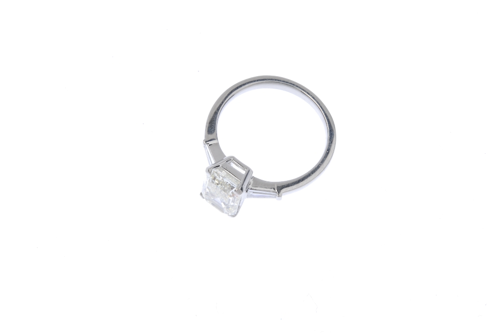 * A diamond single-stone ring. The rectangular-shape diamond, with tapered baguette diamond sides, - Image 2 of 3