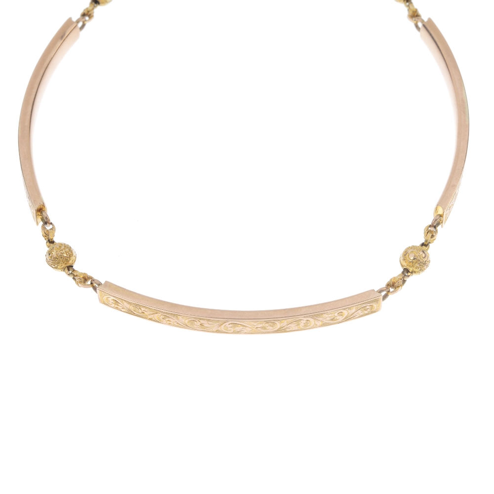 A late 19th century 9ct gold necklace. Designed as a series of curved bar links, with engraved