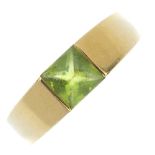 A peridot ring. The square-shape peridot cabochon, inset to the tapered band. Ring size N. Weight