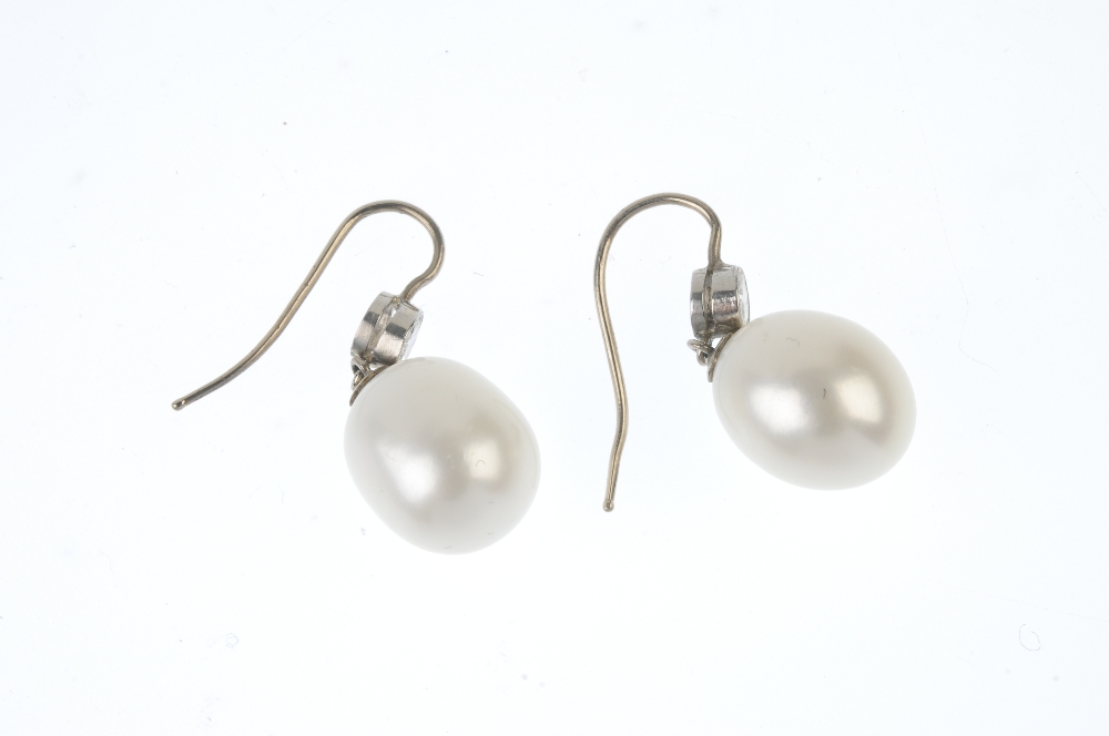 A pair of diamond and cultured pearl ear pendants. Each designed as a cultured pearl drop, suspended - Image 2 of 2