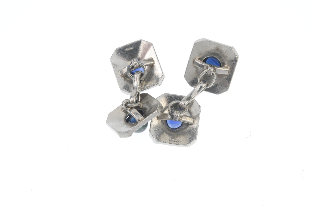 A pair of sapphire cufflinks. Each designed as a rectangular-shape panel, inset with a circular- - Image 2 of 2
