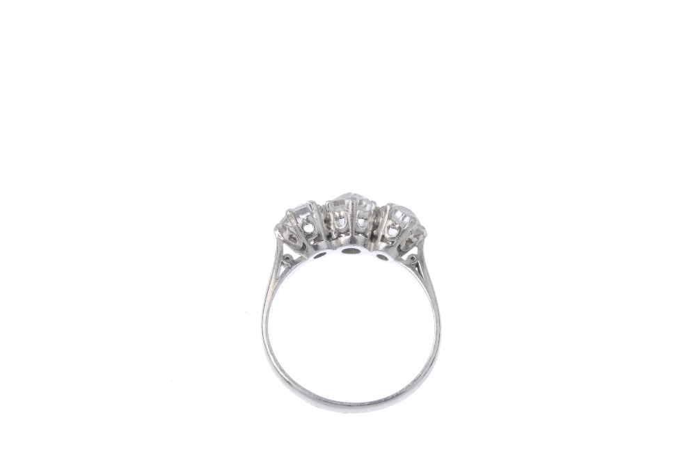 A diamond three-stone ring. The old-cut diamond line, to the plain band. Estimated total diamond - Image 3 of 3