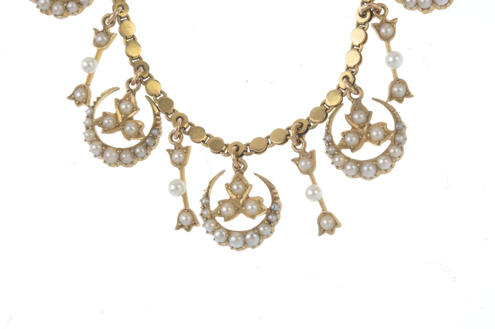 An early 20th century 15ct gold split pearl necklace. Designed as a series of split pearl crescent - Image 2 of 3