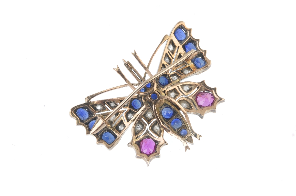 A diamond and gem-set brooch. Designed as a butterfly, set throughout with vari-cut rubies, - Image 2 of 2