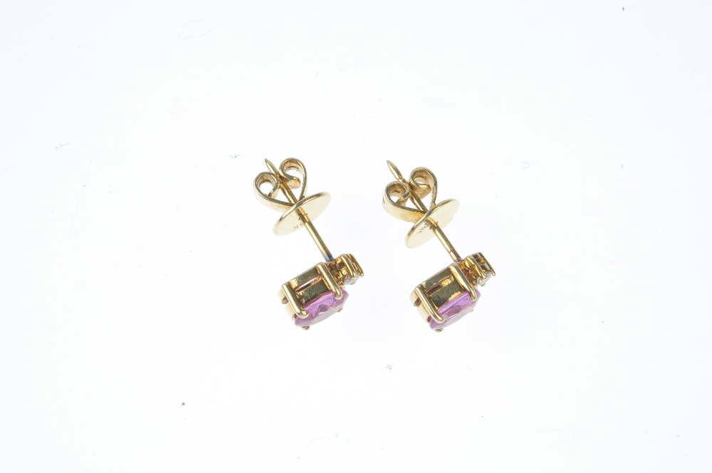 A pair of sapphire and diamond ear studs. Each designed as an oval-shape pink sapphire, with a - Image 2 of 2