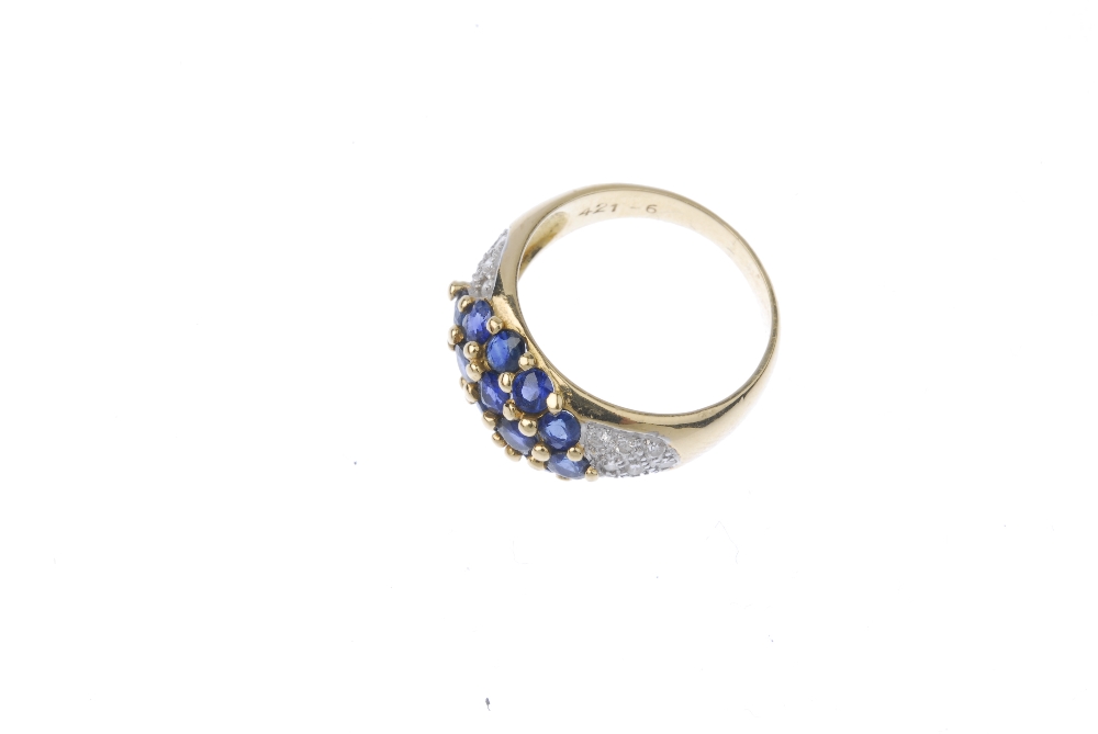 A sapphire and diamond ring. The circular-shape sapphire marquise-shape panel, to the pave-set - Image 2 of 3