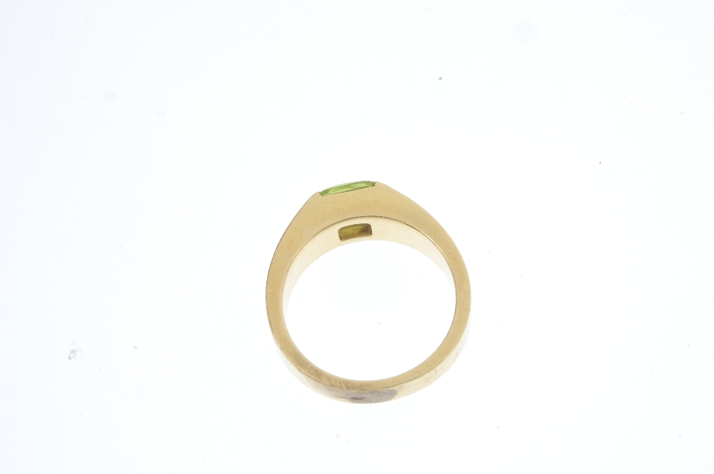A peridot ring. The square-shape peridot cabochon, inset to the tapered band. Ring size N. Weight - Image 2 of 2