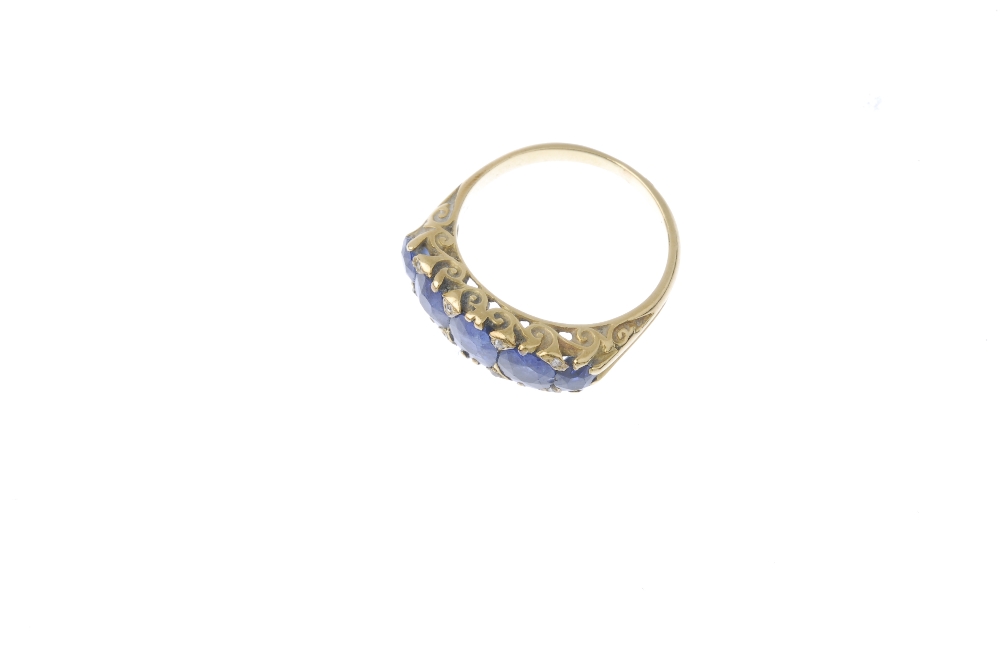 A sapphire and diamond five-stone ring. The oval-shape sapphire graduated line, between diamond - Image 2 of 3