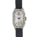 An early 20th century platinum diamond cocktail watch. The rectangular-shape cream dial, with Arabic