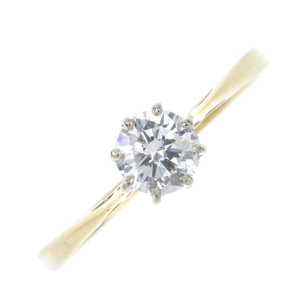 A diamond single-stone ring. The brilliant-cut diamond, to the tapered sides and plain band.
