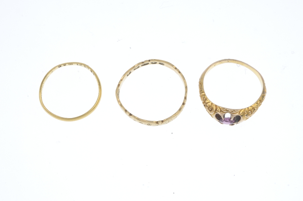 A selection of three rings. To include an oval-shape garnet single-stone ring with floral motif - Image 2 of 3