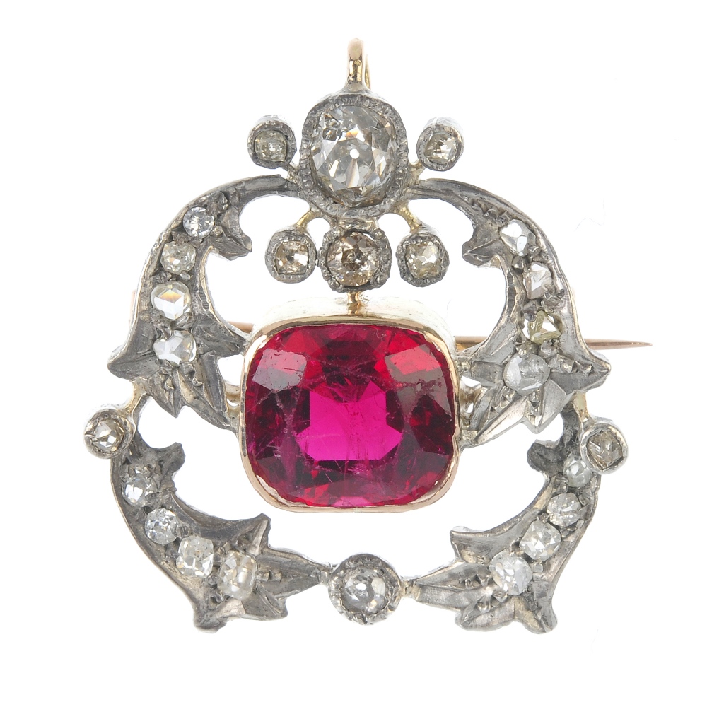 A late 19th century silver and gold, tourmaline and diamond brooch. The cushion-shape pinkish-red