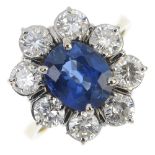 An 18ct gold sapphire and diamond cluster ring. The oval-shape sapphire, within a brilliant-cut