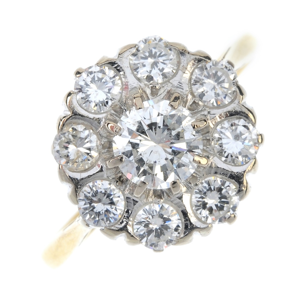 An 18ct gold diamond cluster ring. The brilliant-cut diamond, within a similarly-cut diamond