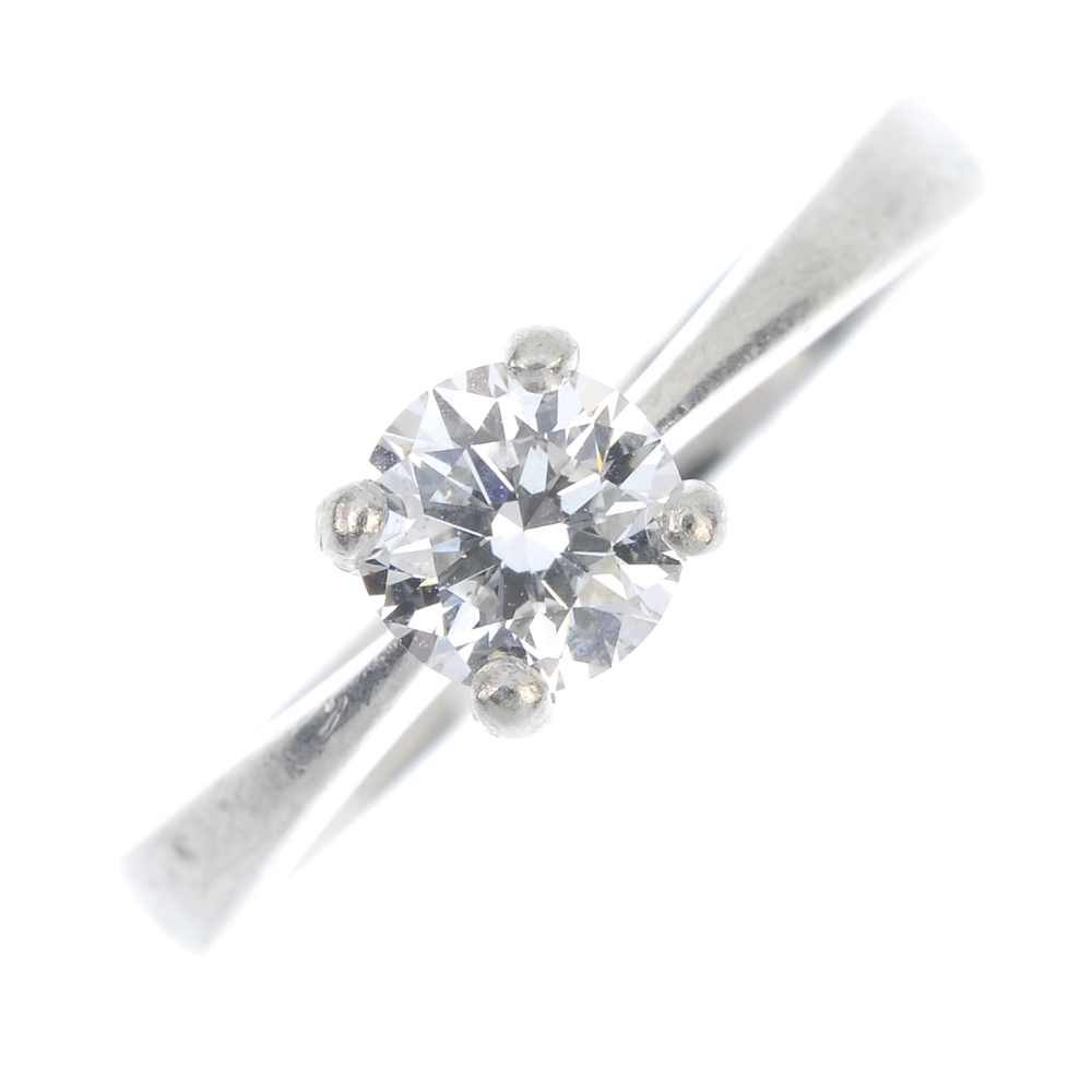 A platinum diamond single-stone ring. The brilliant-cut diamond, weighing 0.55ct, to the tapered