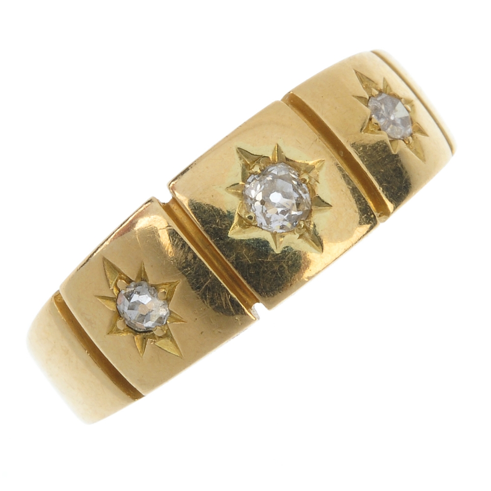 A late Victorian 18ct gold diamond three-stone ring. The graduated old and single-cut diamond star