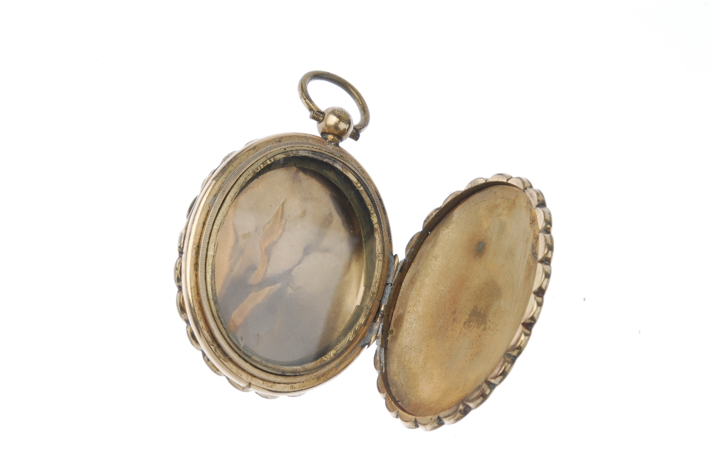 A late 19th century double sided locket. Of oval outline, engraved with scrolling floral motif, - Image 2 of 2