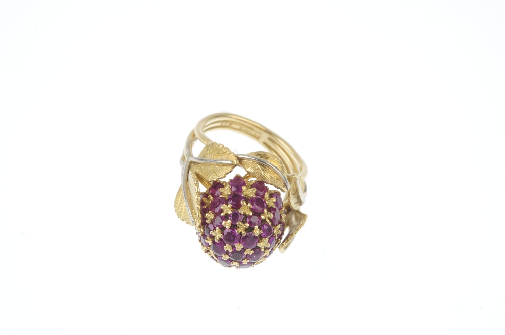 A 1950s 18ct gold ruby dress ring. The pave-set ruby bombe panel, within a bi-colour, textured - Image 2 of 3