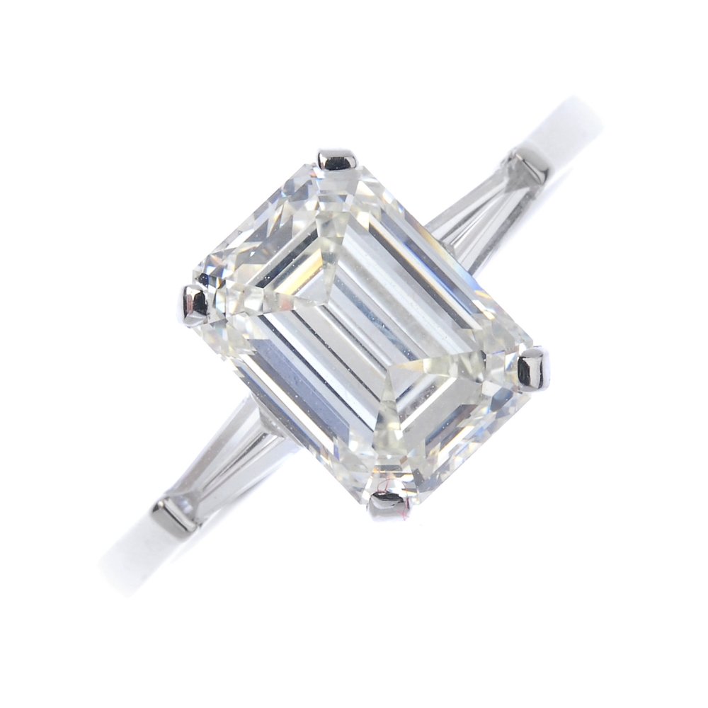 * A diamond single-stone ring. The rectangular-shape diamond, with tapered baguette diamond sides,