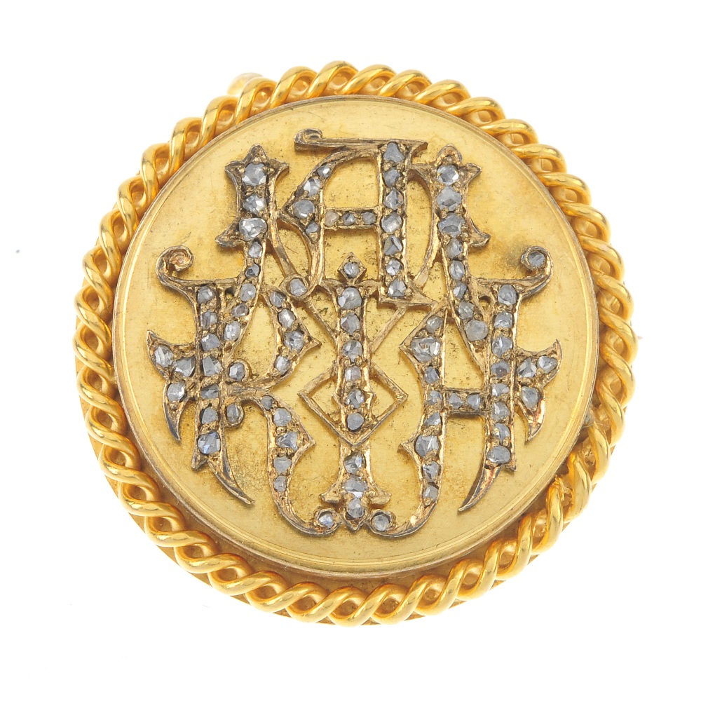 A late 19th century gold diamond brooch. The rose-cut diamond monogram, within a rope-twist
