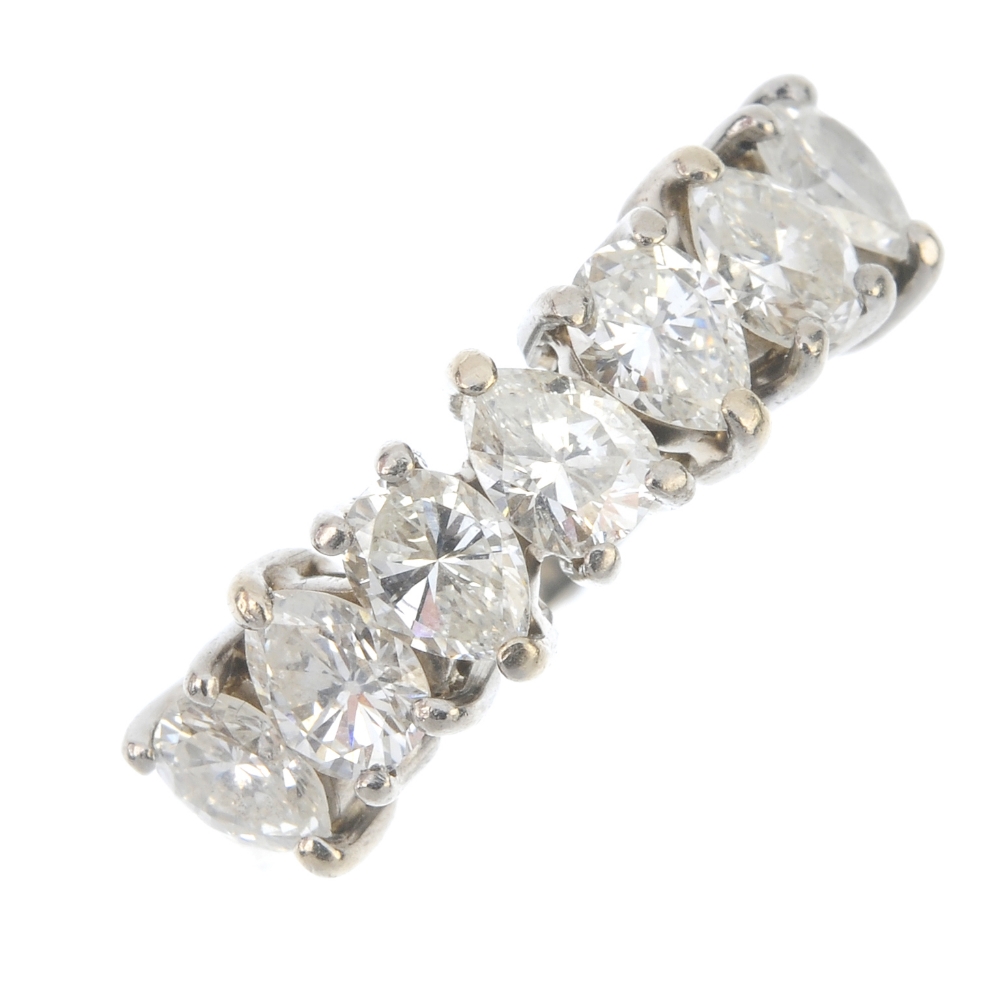 An 18ct gold diamond seven-stone ring. The pear-shape diamonds, to the plain band. One diamond