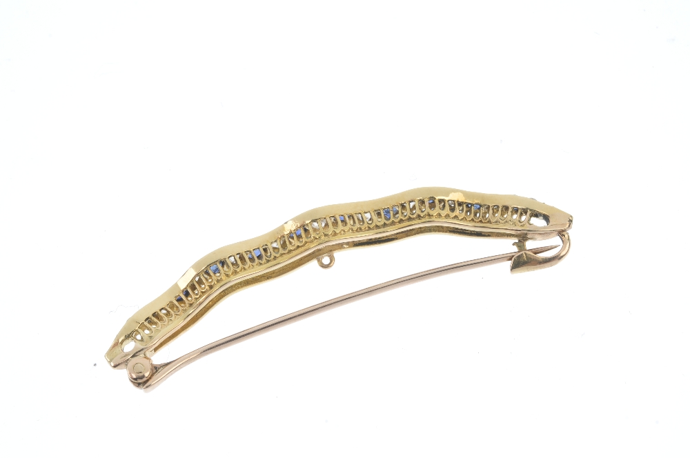 A sapphire and diamond bar brooch. Designed as an alternating circular-shape sapphire and old-cut - Image 2 of 3