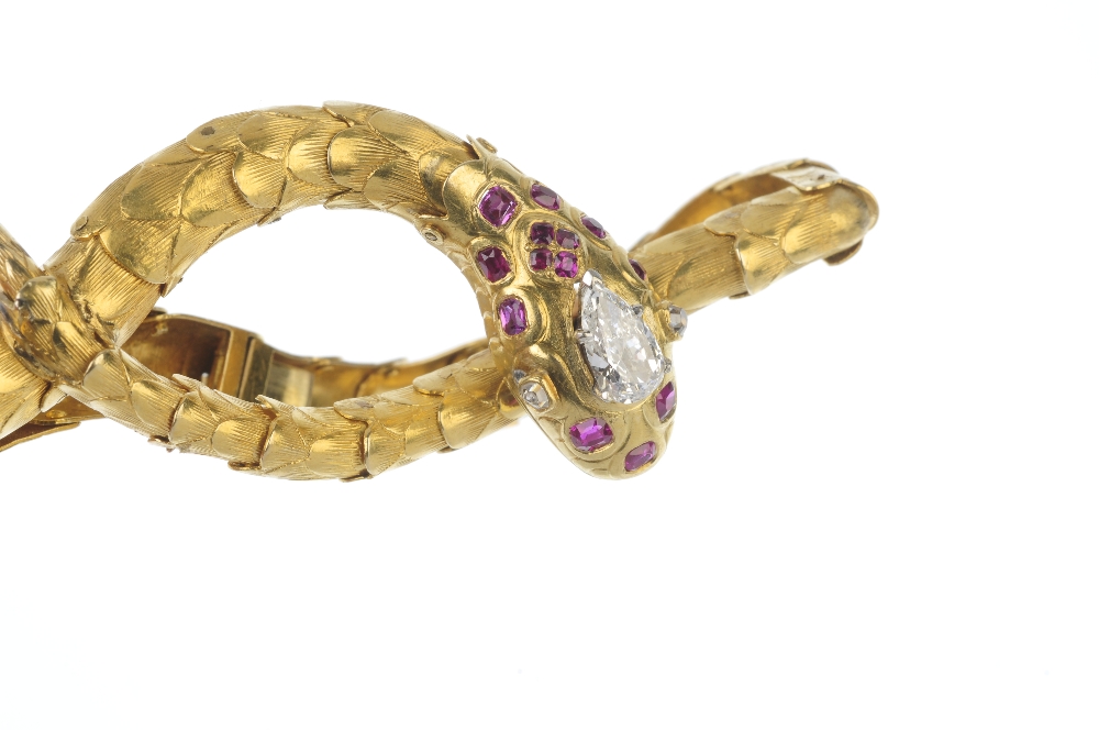 A diamond and ruby snake bracelet. The snake head set with a pear-shape diamond, with diamond - Image 3 of 3