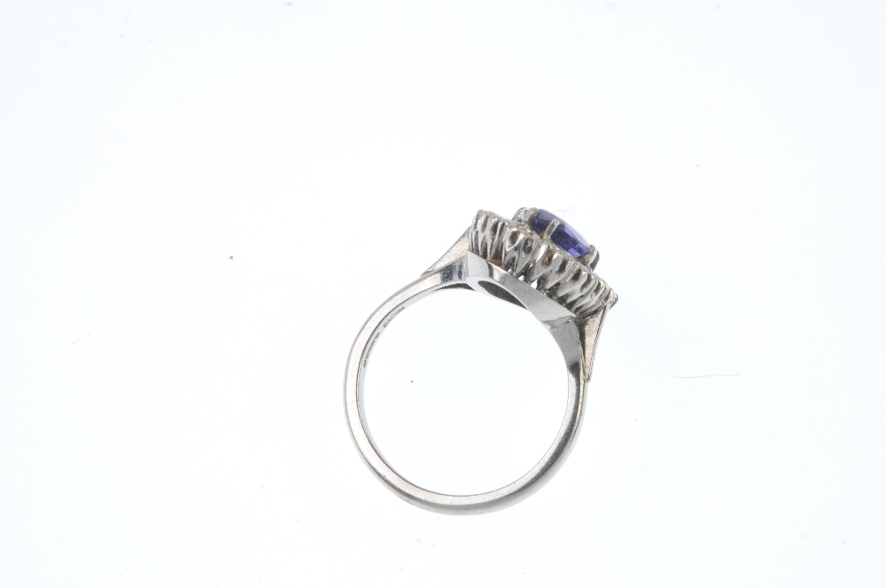 An 18ct gold tanzanite and diamond cluster ring. The oval-shape tanzanite, within a brilliant-cut - Image 3 of 3