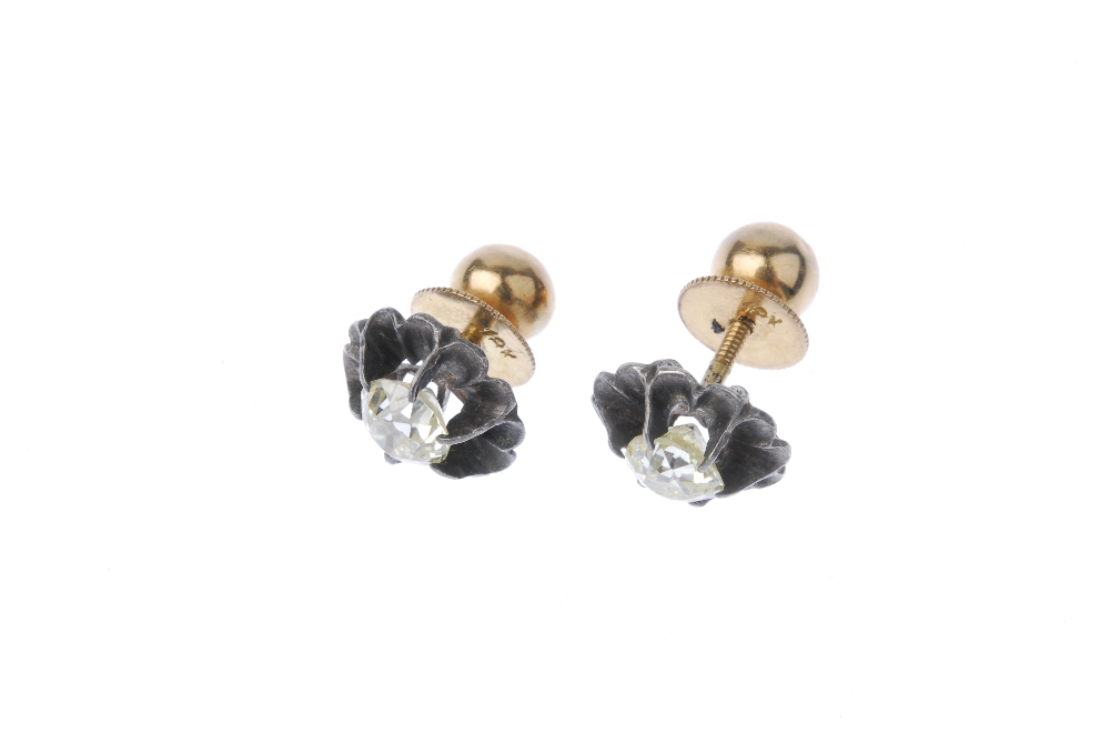 A pair of diamond ear studs. Each designed as an old-cut diamond, within a scalloped surround. - Image 2 of 2