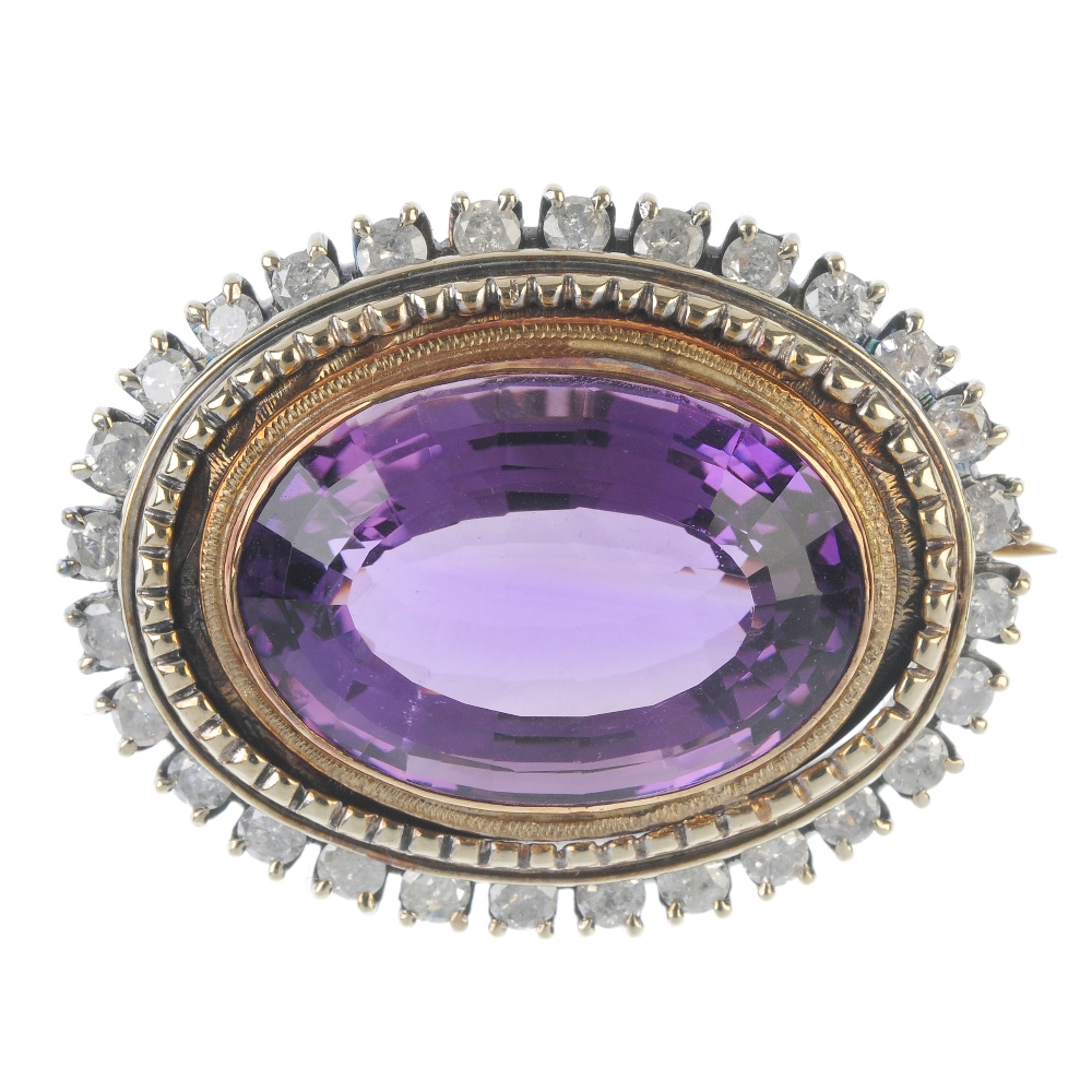 An amethyst and diamond brooch. The oval-shape amethyst collet, within a brilliant-cut diamond