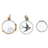 A selection of three early 20th century pendants. To include a gold rock crystal locket, a gold