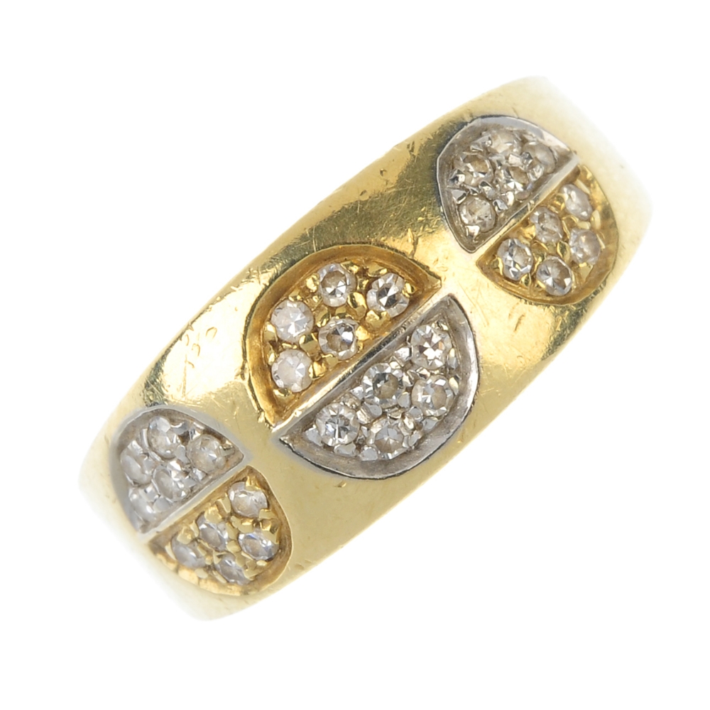 A diamond dress ring. Comprising three pave-set diamond bi-colour discs, inset to the tapered