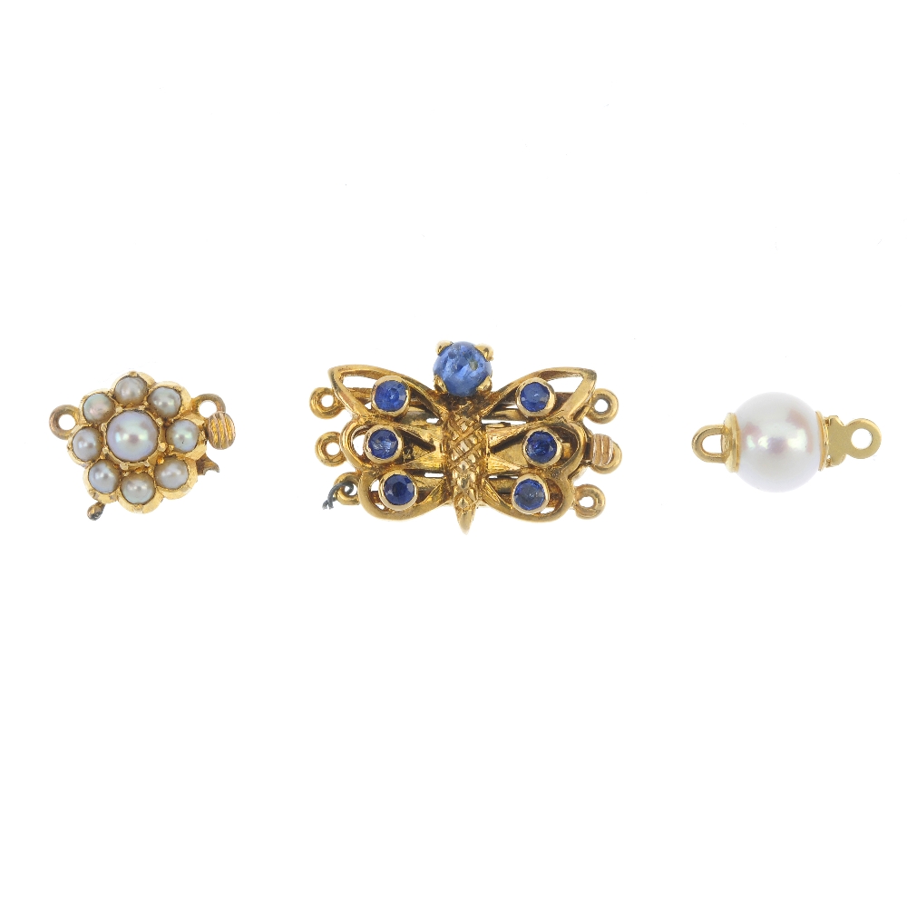 A selection of three clasps. To include a sapphire butterfly clasp, a mid 20th century split pearl