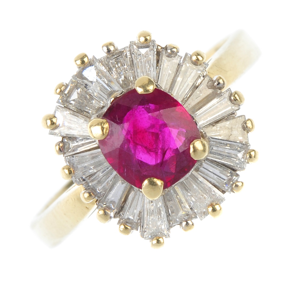 A ruby and diamond cluster ring.  The cushion-shape ruby, within a tapered baguette-cut diamond