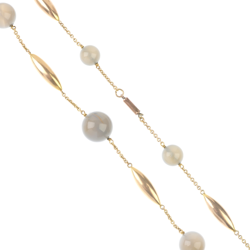 An early 20th century gold agate bead necklace. Designed as a series of graduated polished grey
