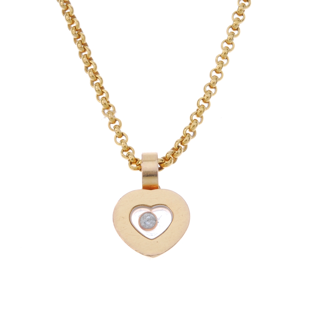 CHOPARD - an 18ct gold 'Happy Diamonds' pendant. The free-moving brilliant-cut diamond collet,